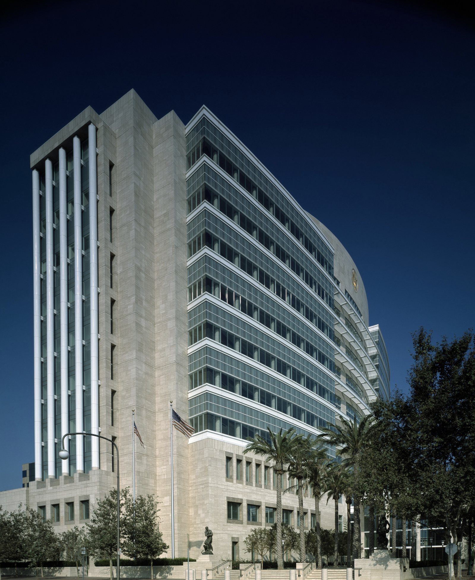Ronald Reagan Federal Building and United States Courthouse in Santa Ana, California, against a deep blue evening sky